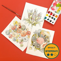 Three illustrated paintings with fall themed designs on a red background, accompanied by watercolor paints and a brush.
