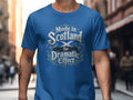 Blue t-shirt with "Made in Scotland for Dramatic Effect" text and Scottish thistle design.